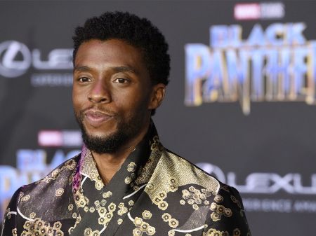 Chadwick Boseman smiles while posing for a picture